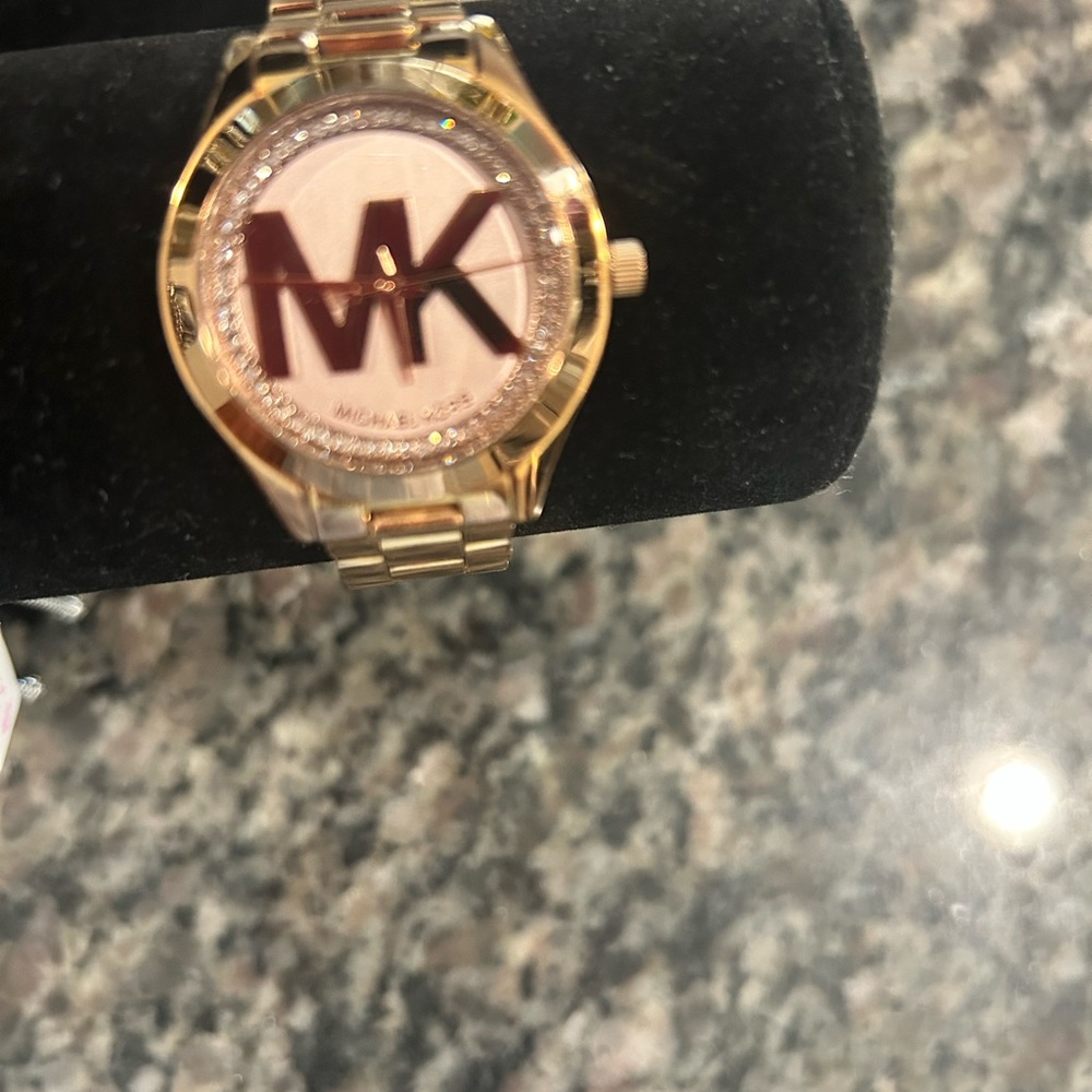 Michael Kors Rose Gold Watch with Rose Gold Face surrounded by diamonds